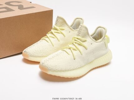 The image displays a pair of off-white sneakers with a Primeknit upper that ensures excellent breathability and a snug fit. The laces are color-coordinated with the upper, contributing to a minimalist and stylish design. The sole features a translucent Boost technology, which is highly regarded for its superior cushioning and energy return. The pull tab on the heel facilitates easy wearing and removal. These shoes are suitable for both casual daily wear and sports activities, making them a versatile choice due to their contemporary design and comfortable wear experience.