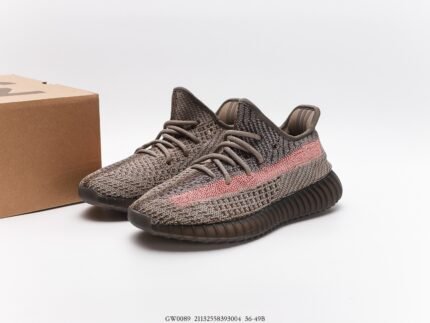 This is a pair of exquisitely designed sneakers with a gray-toned Primeknit upper that incorporates pink accents for a pop of color. The laces are coordinated with the upper, maintaining a cohesive look. The outsole is made of dark rubber with a distinctive pattern designed to offer good cushioning and traction. These shoes are not only suitable for sportswear but also for casual daily occasions, making them an ideal choice with their stylish appearance and comfortable wear experience.