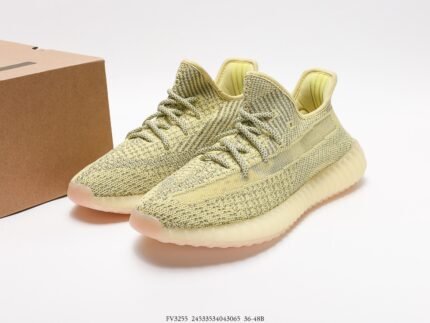 The image showcases a pair of light yellow sneakers with a Primeknit upper that displays a fine texture and offers good breathability. The laces match the color of the upper, and the overall design is simple yet stylish. The sole is translucent light yellow, coordinating with the upper and providing cushioning and traction. The design of these shoes focuses on comfort and a modern feel, making them very suitable for casual daily wear or sports activities.