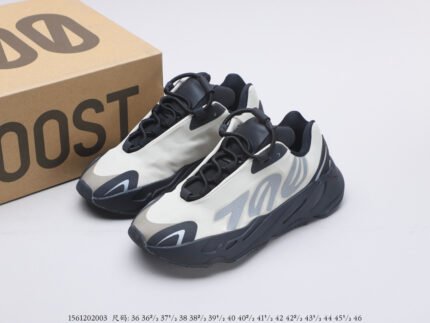 Black and white sneakers next to a branded shoebox