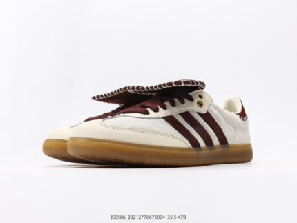 White sneakers with brown stripes and brown soles