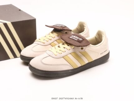 Beige sneakers with gold stripes and brown tongue label