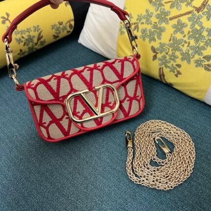 Red and beige crossbody bag with gold chain strap and metal clasp.