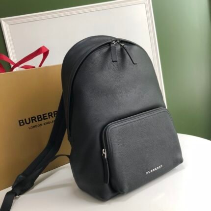 A black leather backpack with front pocket and top zipper closure.