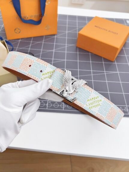 Light-colored Louis Vuitton belt with a dragonfly buckle