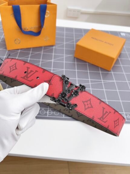 Louis Vuitton red belt with pattern, black floral buckle