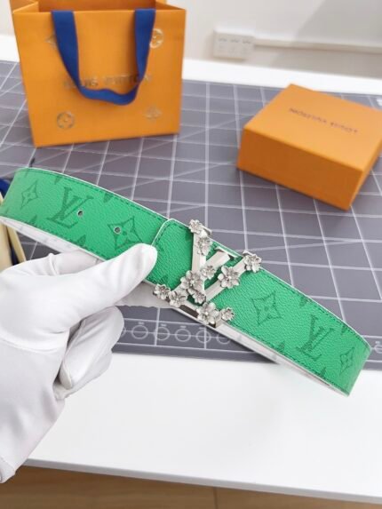 Louis Vuitton green patterned belt with silver floral buckle