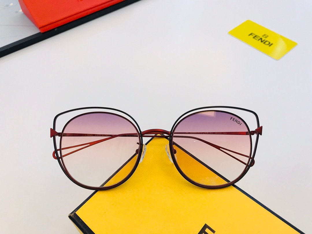 Fendi Sunglasses Collection The image is a collage showcasing various Fendi sunglasses. The top left photo shows a close-up of the side view of the sunglasses, highlighting the sleek frame and the Fendi logo on the temple. The top right photo provides a detailed view of the front of the sunglasses, featuring gradient lenses and the Fendi logo. The bottom left photo displays multiple pairs of sunglasses in different colors, including red, blue, pink, green, and yellow. The bottom right photo shows a close-up of the sunglasses' arms, highlighting the model number and size details.