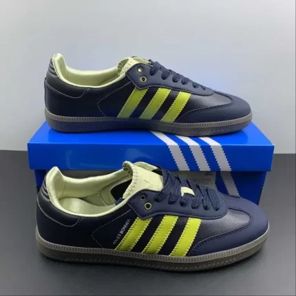 Dark blue sneakers with neon green stripes, placed on a blue shoebox