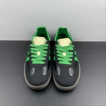 Dark grey sneakers with green laces and details