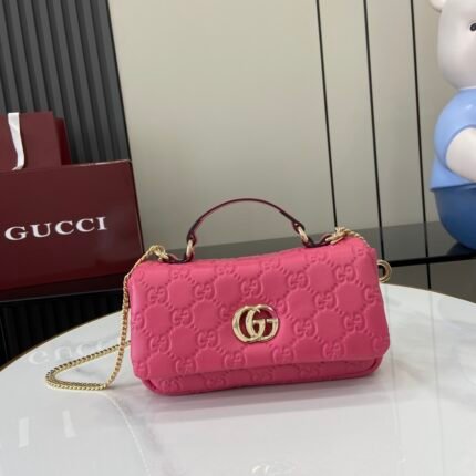 Pink GG pattern handbag with gold metal clasp