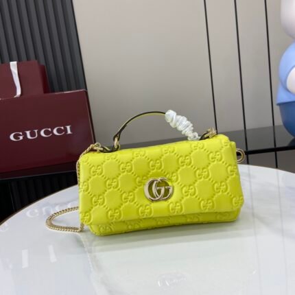 Bright yellow GG pattern handbag with silver metal clasp