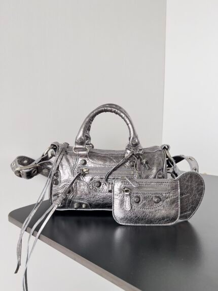 Silver textured leather handbag with multiple pockets and matching wallet.