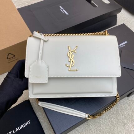 White chain bag with gold letter logo and black packaging boxes.