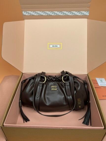Black leather drawstring bag with gold brand logo, placed inside brand packaging box