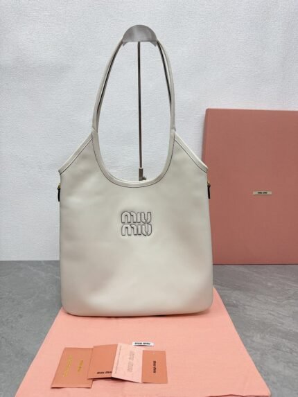Off-white shopping bag with brand logo, pink background, and brand cards