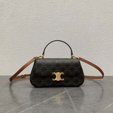 Classic pattern handbag with gold buckle, brown leather strap, on a grey marble background