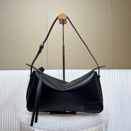 Black leather shoulder bag with gold metal clasp, on a white background