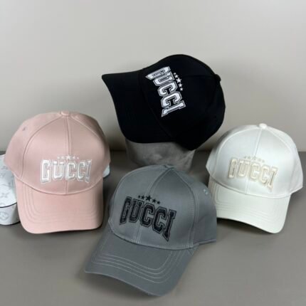 Five hats in different colors, including pink, black, gray, and white, each with a logo, set against a display background.
