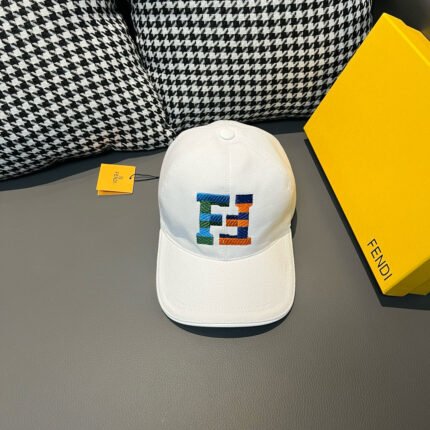 A white cap with a colorful letter pattern, placed next to a yellow box and an orange tag.